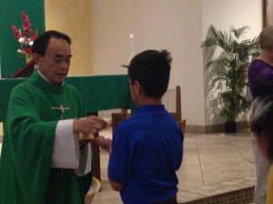 A student receiving Holy Communion.